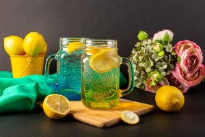front-view-lemon-cocktail-fresh-cool-drink-inside-glass-cups-sliced-whole-lemons